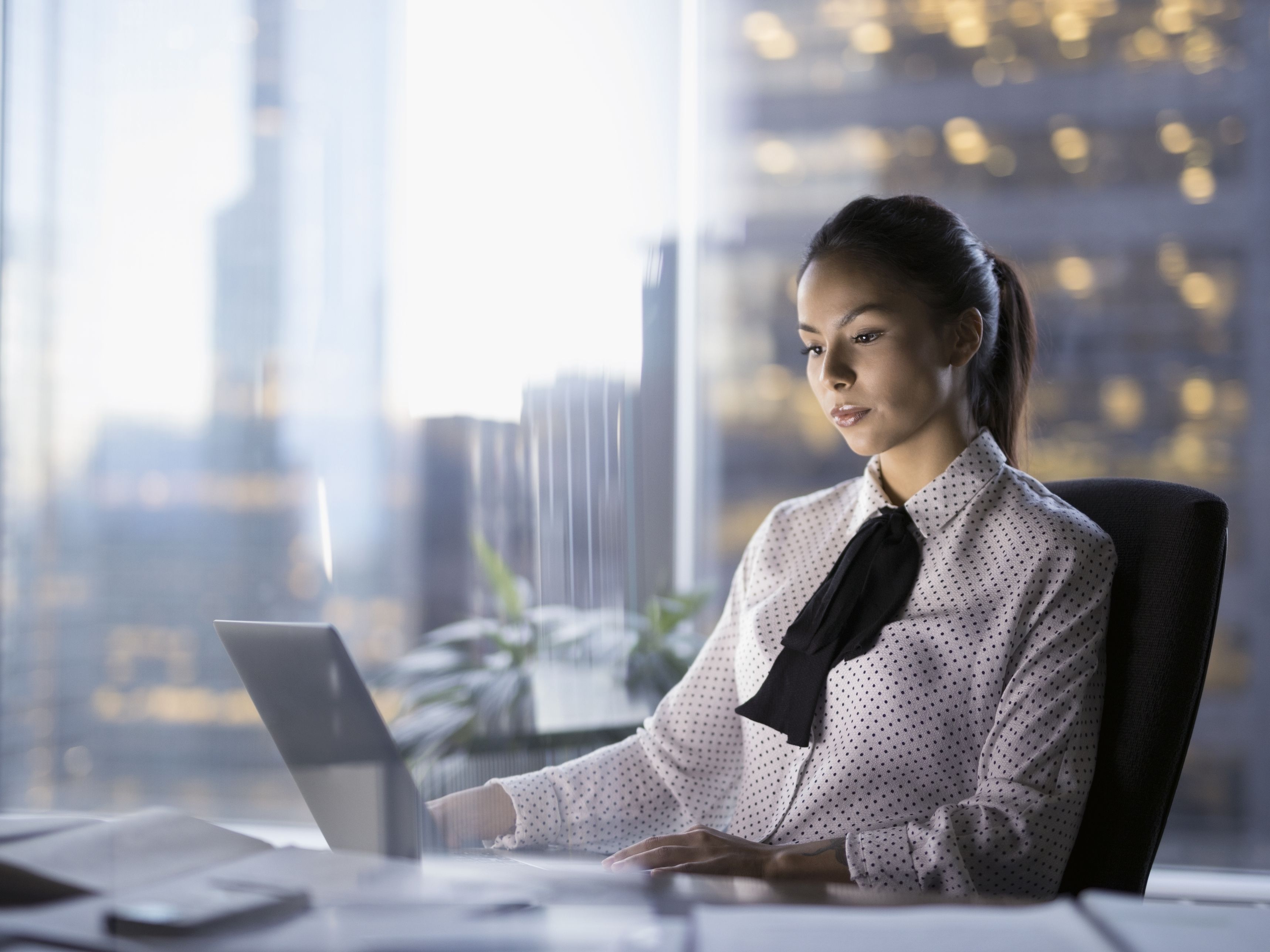 female-lawyer-working-late-at-laptop-in-urban-office-697540591-59a4712968e1a20013536419